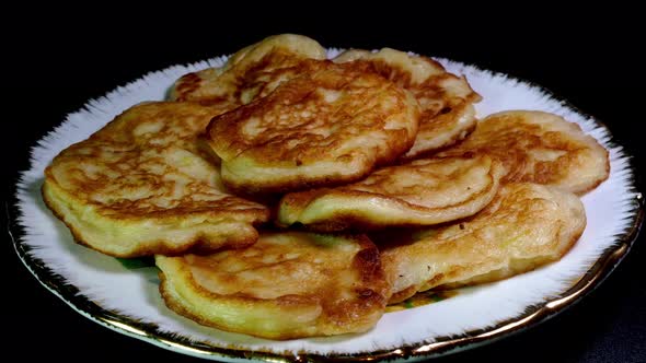 Stack of Fresh Fried Homemade Sweet Pancakes Rotating on Plate