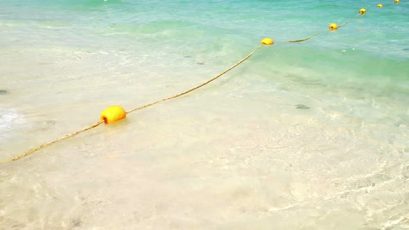 Yellow Buoy with Wave on the Beach 