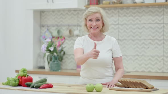 Senior Old Woman Showing Thumbs Up While Standing in Kitchen