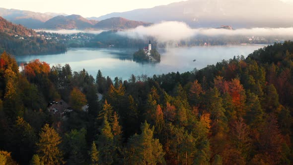 4K Flying around beautiful Bled lake landmark with church on the island at sunrise
