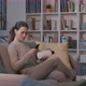 Young woman sitting on the couch and wearing a VR headset - VideoHive Item for Sale