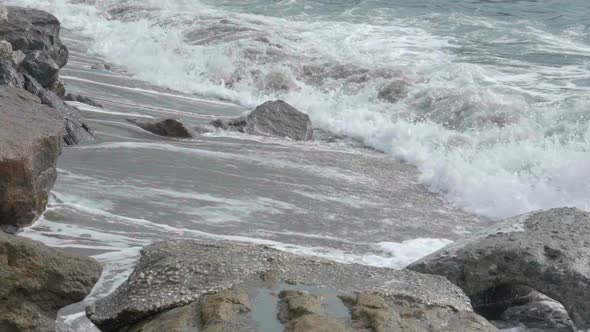 Foamy Ocean Waves Rolling Over Sandy Coast with Rocks, Power of Nature