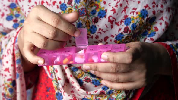 Young Asian Women Taking Pills From Pill Box 