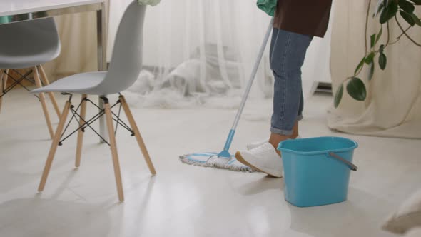 Legs of Woman Mopping Floor