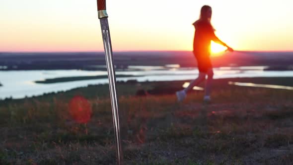 Swords Training  Young Woman Training on Nature While Sunset  Second Sword Drove Into the Ground
