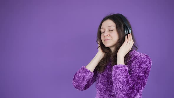 Woman Enjoys Listening to Music Via Wireless Headphones