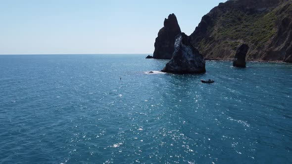 Aerial View From Above on Azure Sea and Volcanic Rocky Shores