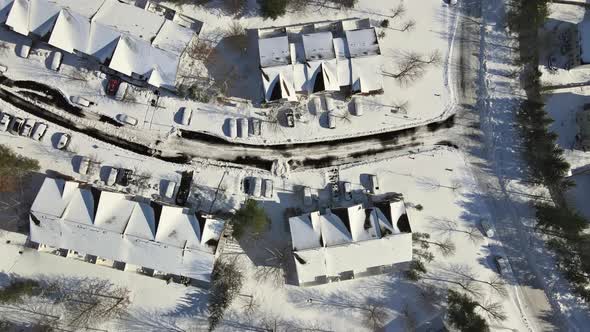 Aerial View Over Private Houses in Wintertime of Snow Covered Traditional Housing Suburbs