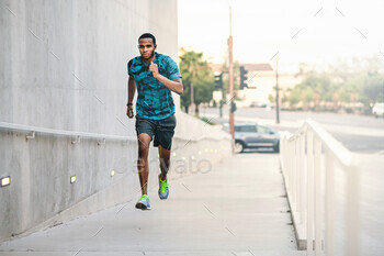 Focused runner sprinting in urban setting.