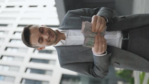 Handsome Rich Man Wearing Stylish Suit Counting Money Near Office Building Vertical Video