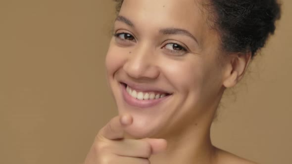 Beauty Portrait of Young African American Woman Listening Attentively Pointing Finger at Viewer