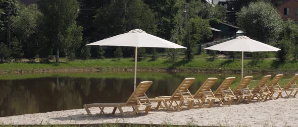 Beach Area with Sand and Loungers Near a Small Lake in a Cottage Village in Nature Rest Near the