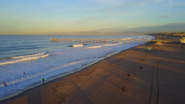 Aerial drone uav view of a lifeguard tower, pier, beach and ocean.