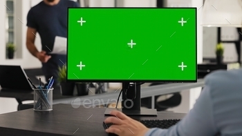 Worker at desk with greenscreen desktop