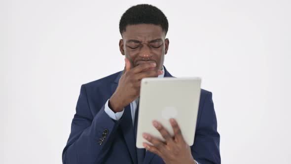 African Businessman Reacting to Loss on Tablet on White Background