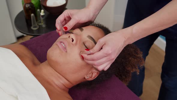 Beauty Specialist Doing Facial Massage with Suction Vacuum Cups Indoor