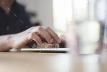 Closeup of a hand interacting with a touchscreen device.