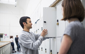 Two students chatting by the lockers.