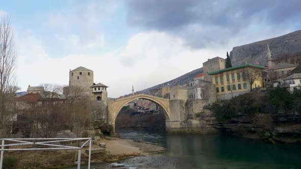 Panning clip of Old Bridge and Old Town with an overcast sky in Mostar Bosnia and Herzegovina