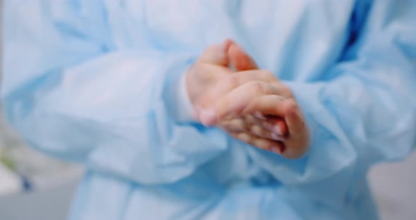 Doctor Disinfecting Hands with Bactericidal Gel