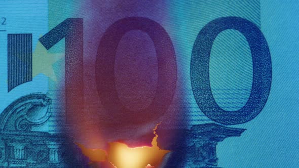 Burning of 100 Euro Banknote on Black Bacground Closeup
