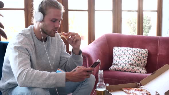 Man listening to music with mobile phone at home