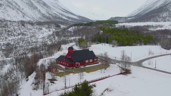 Red church in a dramatic winter landscape in Kåfjord, Northern Norway