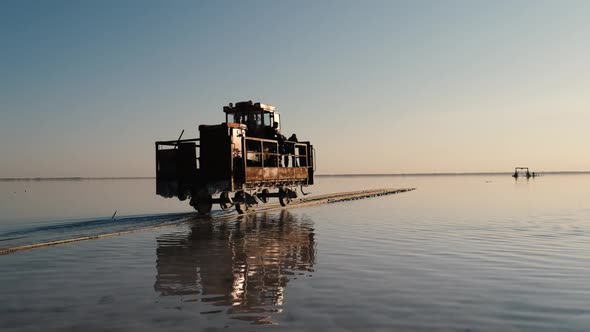 An Old Train Travels on a Railway Laid in the Water Across a Salt Lake