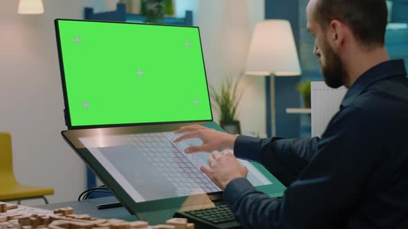 Man Architect with Green Screen Analyzing Building Model