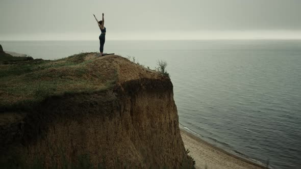 Flexible Woman Making Yoga Exercise on Hilltop