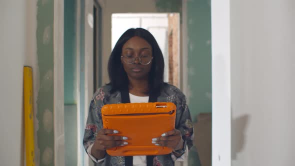 Afro Female Surveyor with Digital Tablet Carrying Out House Inspection