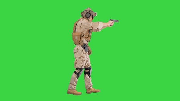 Marine Walking with Pistol and Shooting on a Green Screen, Chroma Key.