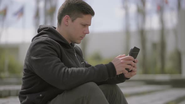 Concentrated Young Man Using Tablet Pc Outdoor