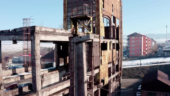 Ruins Of An Abandoned Old Industrial Warehouse Building On A Sunny Winter Day. ascending shot