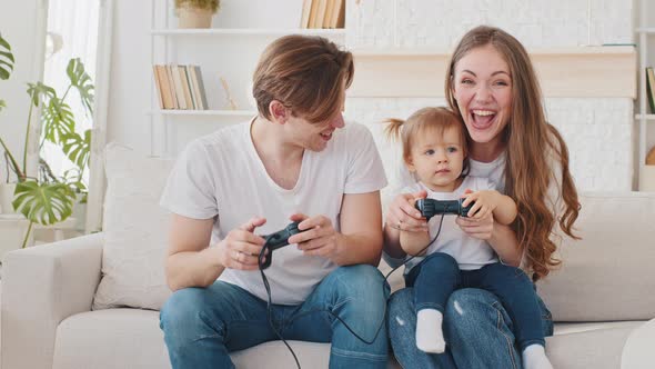 Caucasian Young Millennial Family Man Father and Beautiful Mother Woman Playing Video Game Console