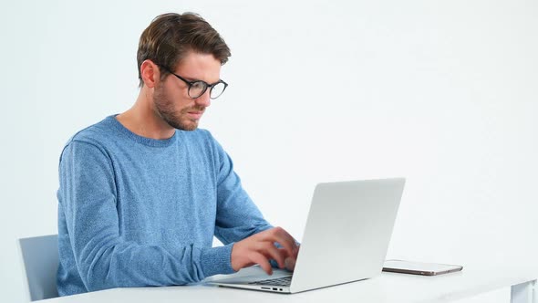 Thoughtful male executive working on personal computer laptop