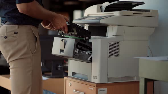 Hand Swapping Cartridge On Multifunctional Printer. Man From Helpdesk Replace Cartridge In Printer.