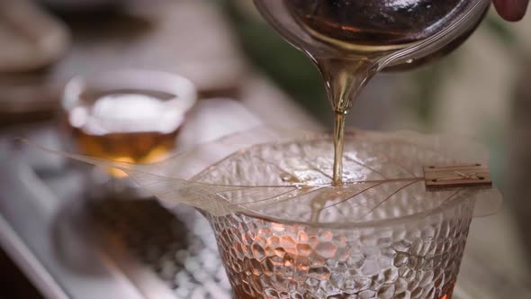 Pouring Oolong Chinese Tea in Glass Cup