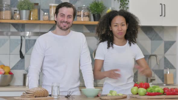 Mixed Race Couple Doing Video Call While Standing in Kitchen