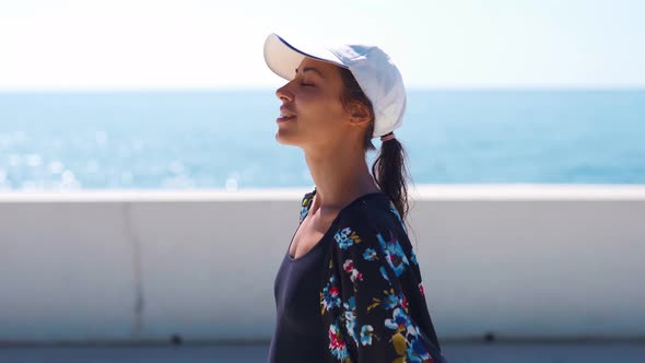 Outside Closeup Portrait Beautiful Stylish Sporty Woman in Black Swimsuit and White Cap Walking