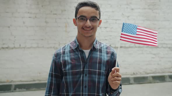 Slow Motion of Happy Arab Man Holding American National Flag and Smiling Outdoors