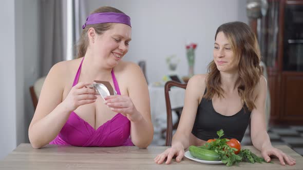 Portrait of Obese Caucasian Woman Eating Sweet Delicious Chocolate As Slim Arrogant Lady Chewing