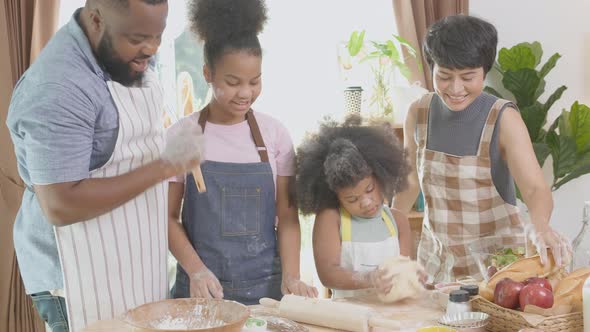 African America family wearing apron thresh flour for cooking and dancing and song together.