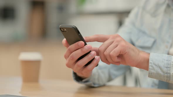 Close Up of Creative Young Man Using Smartphone