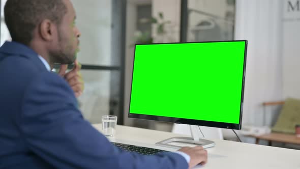 African Businessman Using Desktop with Green Chroma Key Screen