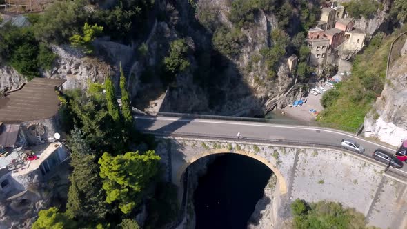 Fiordo di Furore bridge on Amalfi coast, aerial drone rising reveal