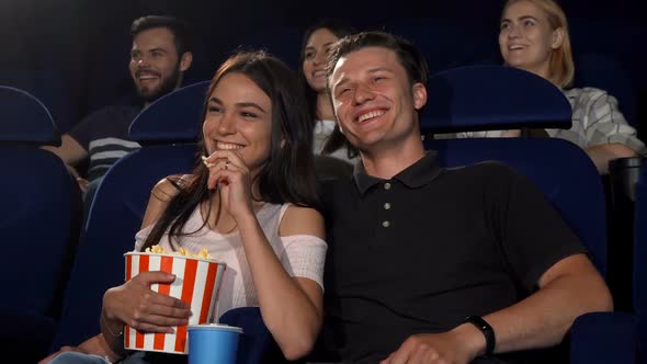 Happy Couple Laughing While Watching Comedy Movie at the Cinema