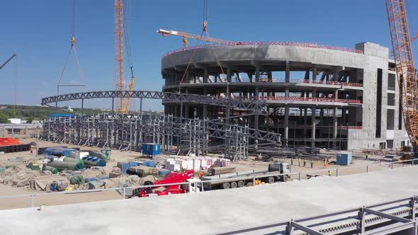 Lifting of Metal Frame Near Building of Future Sports Arena