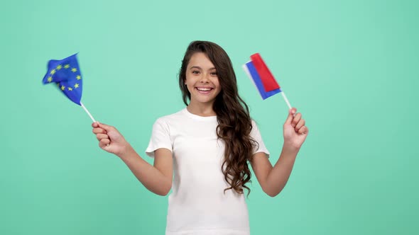 Extremely Happy Kid Waving European Union and French Flag on Blue Background French Language