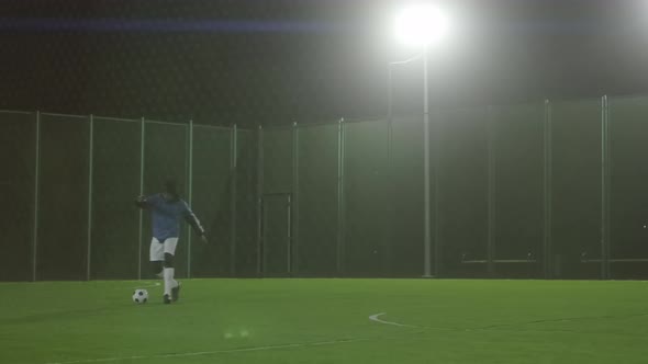 Male Soccer Player Practicing Alone